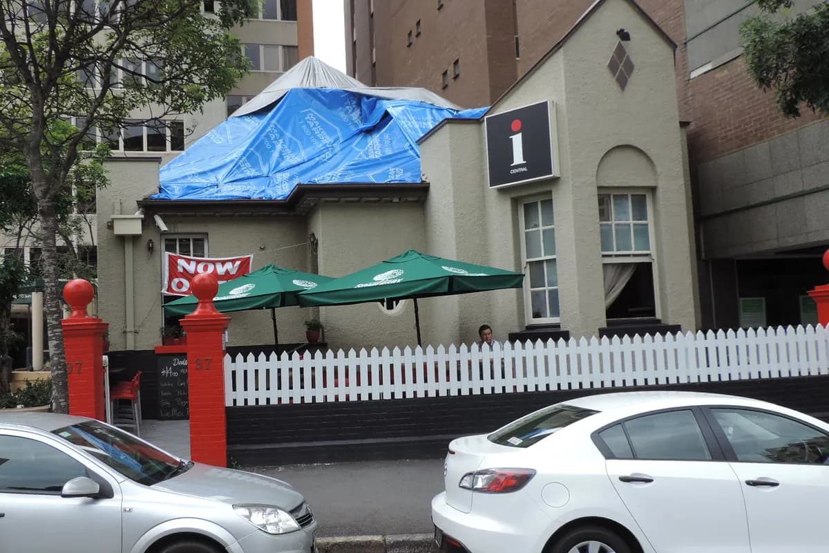 A house with visible storm damage to its roof