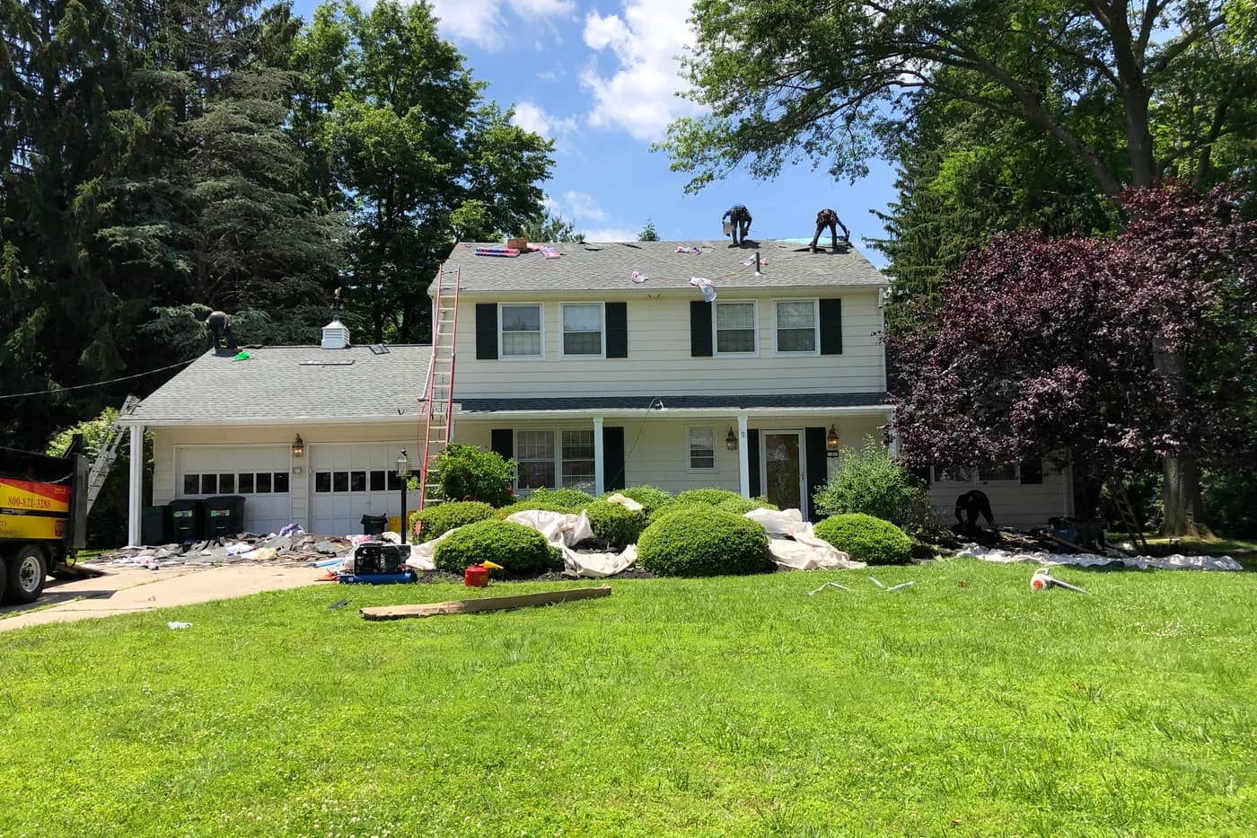 Roofing crew working on the roof of a two-storey New Jersey house